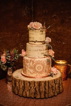 a wedding cake sitting on top of a tree stump