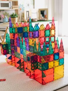 a multicolored building made out of plastic blocks sitting on top of a table