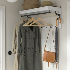 a coat rack with an umbrella, hat and purse hanging from it's hooks