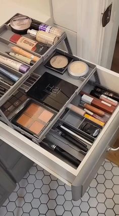 an organized makeup drawer in a bathroom