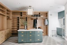 a large walk in closet with wooden cabinets and drawers