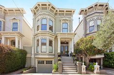 two story victorian style house with three car garages on the front and second floor