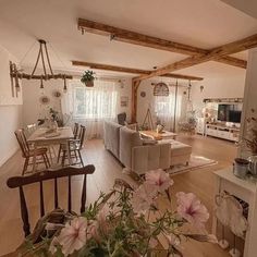 a living room filled with furniture and flowers