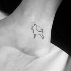 a small dog tattoo on the ankle is shown in black and white, with an outline of a dog's head