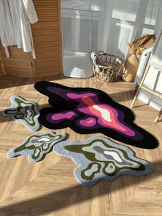 three rugs on the floor in a room