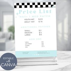 a price list on top of a table in front of a white wall with a black and blue checkered design