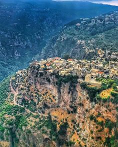 an aerial view of a village on the side of a mountain