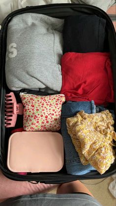 an open suitcase filled with clothes and other items