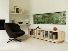 a living room with a chair and book shelf