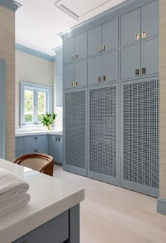 an image of a kitchen with gray cabinets and white counter tops on the phone screen