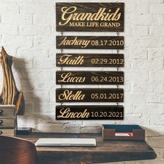 a wooden sign that says grandkids make life grand on the side of a desk