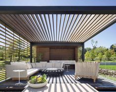 an outdoor living area with couches, tables and chairs