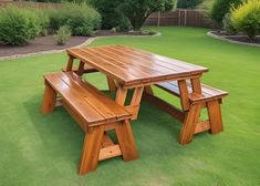 a wooden picnic table and benches in the grass