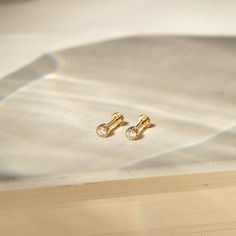 Our take on the classic diamond stud - with a modern twist! The Diamond Bezel Flat Back Earrings has sweet beaded details around the lab-grown diamond. Crafted delicately in 14k solid gold, these studs are both light and durable, offering a touch of confident sparkle throughout your daily adventures. DETAILS 14k solid gold flat back earring with 4mm internal thread Post: 6.5mm length, 18 gauge Lab-grown diamond: 2mm Diamond carat: 0.035 ct Diamond color & clarity: DEF-SI Weight: 0.21g Available Product Shoot, Fine Gold Jewelry, Flat Back Earrings, Types Of Gold, Chic Necklace, Gold Flats, Trendy Necklaces, Diamond Carat, Solid Gold Jewelry