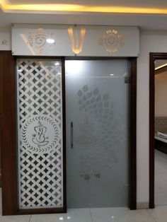 a glass door with intricate designs on the outside and inside, in front of a white wall