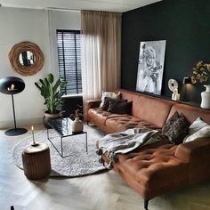 a living room filled with lots of furniture next to a large window covered in curtains