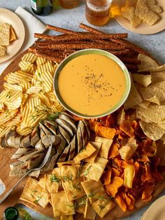 a platter filled with chips, dip and tortilla chips on a table