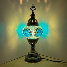 a lamp that is sitting on top of a table with a blue light behind it