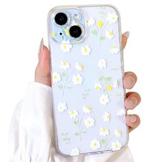 a person holding up a phone case with flowers on it