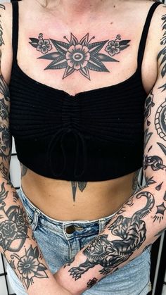 a woman with tattoos on her chest and arms