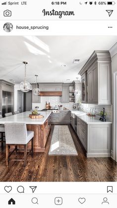 a large kitchen with wooden floors and gray cabinets