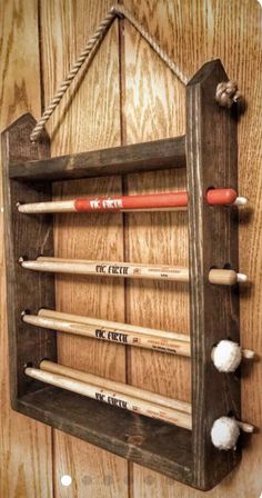 an old wooden rack with baseball bats hanging from it