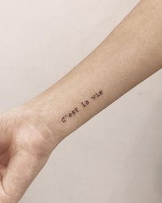 a person's arm with a small tattoo that says, crist it up