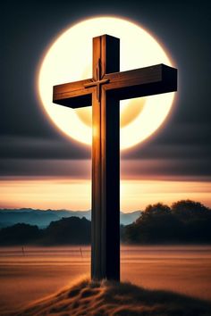 a cross on top of a hill with the sun in the background