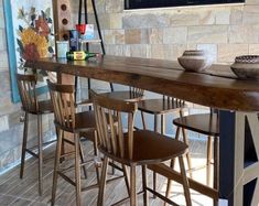 a bar with several chairs and bowls on it