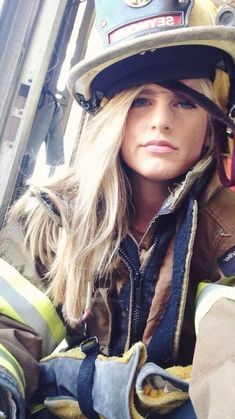 a woman firefighter sitting in the back of a truck