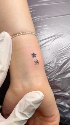 a small four leaf clover tattoo on the left side of the foot, with three petals at the top