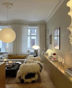 a living room filled with lots of furniture and lamps on top of it's walls