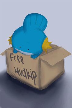 a blue stuffed animal in a cardboard box that says free mudkip on it