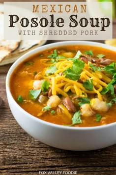 mexican posole soup with shredded pork in a white bowl