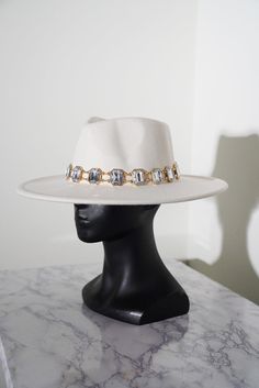 Step into luxury with the Gemstone Glam Fedora. Featuring dazzling jewel stones, this hat strikes the perfect balance between timeless elegance and modern glamour. Whether for a special occasion or daily wear, this fedora instantly enhances your ensemble with refined sparkle. Spot Clean Can be adjusted to made smaller with internal size adjuster Please Read Before Purchasing: Our hats are made to fit average head sizes, the average adult head circumference to be 55cm (21 3⁄4 ) in females and 57cm (22 1⁄2 in) in males. Most of our hat styles start at 24 inches which is 60cm, hence why 95% of our models come with an adjustable band to make the inside smaller! If you want a hat filler that can also be added, just message us to find out how. Colors may vary due to lighting and editing. Fedora Hats For Men, Jewel Stones, White Fedora Hat, White Fedora, Wide Brim Felt Hat, Fedora Hat Men, Hat Styles, Fedora Hats, Dress Hats