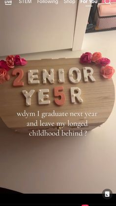 a wooden sign with flowers on it that says, 2 n or 5 r wm i graduate next year and leave my longer childhood behind?