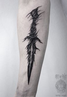 a black and white tattoo design on the arm