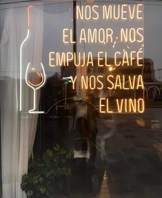 a neon sign is in the window of a restaurant called elvino, which has been closed for business