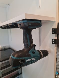 a cordless driller is mounted to the wall