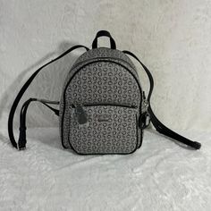 This Guess Mini Backpack Offers A Chic Design With Ample Storage Space, Perfect For Daily Use Or Travel. The Adjustable Straps Ensure A Comfortable Fit. Adjustable Straps Multiple Pockets Stylish Logo Print Durable Material Zip Closure Guess Women's Mini Backpack Style Dd672429 With Blackstraps And Gray Background, With Black G Pattern. It Has The Brand In The Form Of A Plate On The Front Of The Mini Backpack And Silver Spell Out Guess, Silver In Color. It Has Two Compartments, A Front Pocket Wi Guess Bags Backpack, Black Backpack With Logo, Adidas Mini Backpack, Guess Backpack, Tommy Hilfiger Backpack Black, Guess Bags Black, Adjustable Strap Bag, Yellow Backpack, Black G