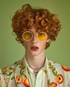 a woman with freckled hair and glasses on her face is looking at the camera