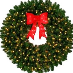 a christmas wreath with red bows and lights