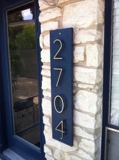 a house number sign on the side of a building