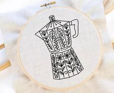 a cross - stitch pattern with a coffee pot in the middle on a white background