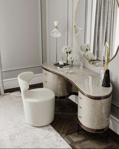 a white desk with a mirror, chair and flower vases in front of it