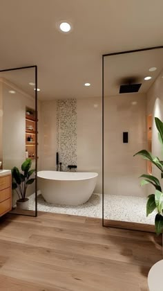 a bathroom with a large bathtub next to a plant in the middle of it