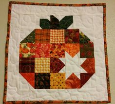 an apple quilted on top of a wall hanging