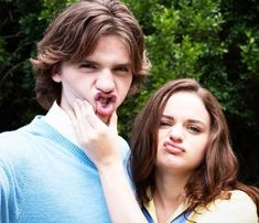 two people standing next to each other with their mouths open and one person making a funny face