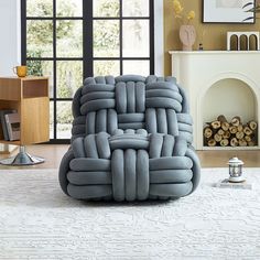 a large inflatable chair sitting on top of a white rug next to a fireplace