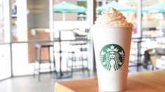 a starbucks drink sitting on top of a wooden table